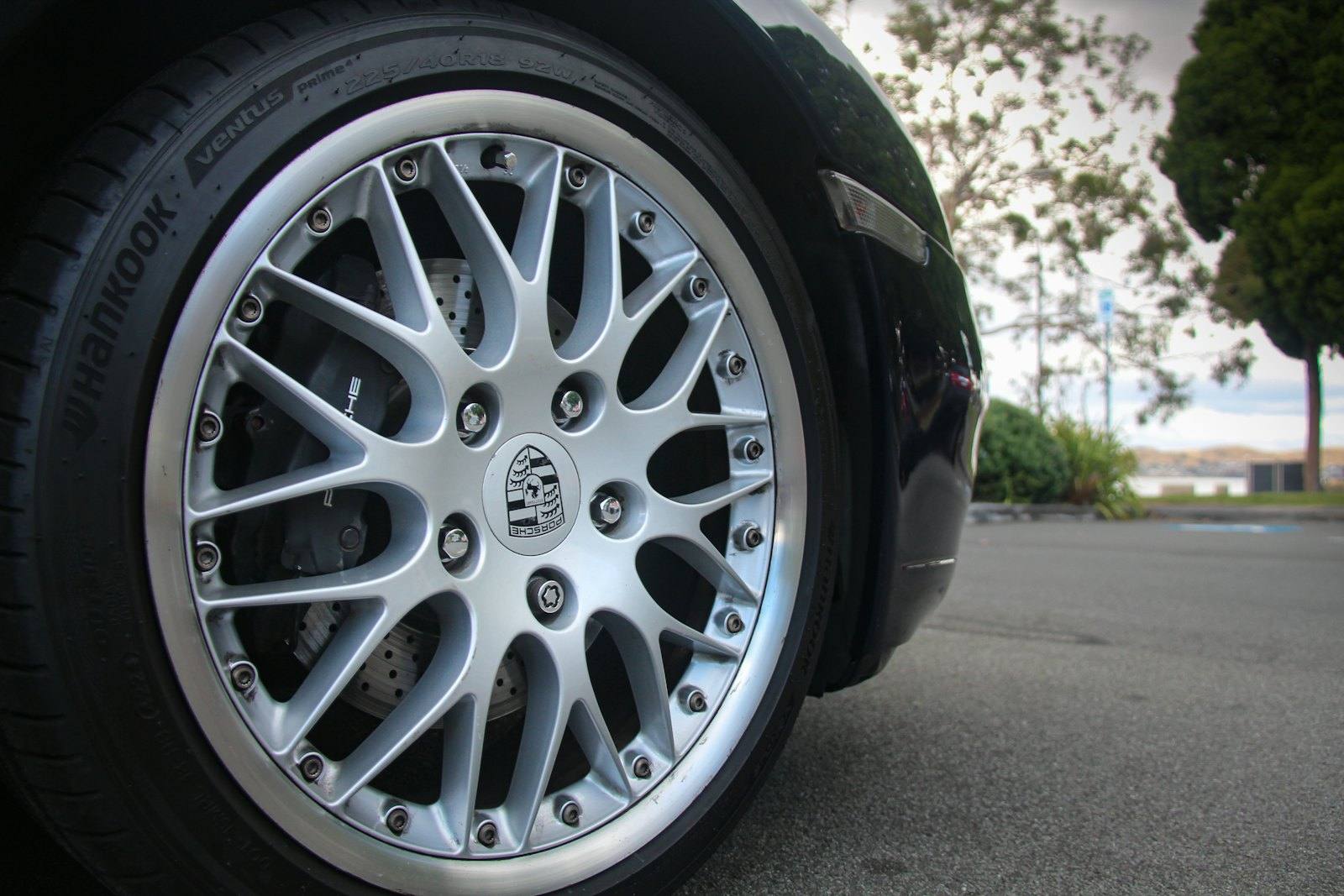 Bright multi-spoke silver alloy wheel in good condition, a finished machined face rather than a damaged rim