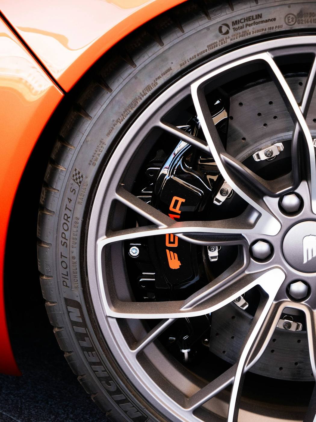Two-tone alloy wheel with dark pockets and bright machined spoke faces, in good condition